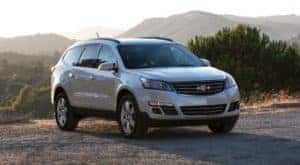 A popular used Chevy Traverse, a silver 2016 Chevy Traverse, is shown parked on a mountain top.