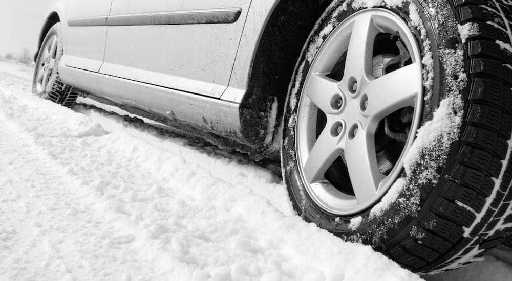 A closeup shows snow and snow tires from a discount tire shop in Cincinnati.