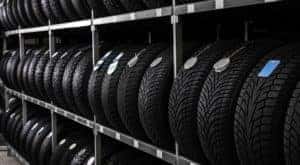 Rows of cheap tires in Cincinnati are shown on a rack.