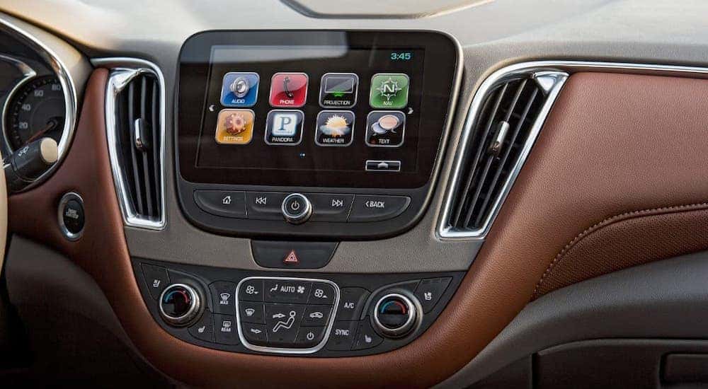 A closeup shows the infotainment screen in a 2018 Chevy Malibu at a Chevy dealer in Cincinnati.