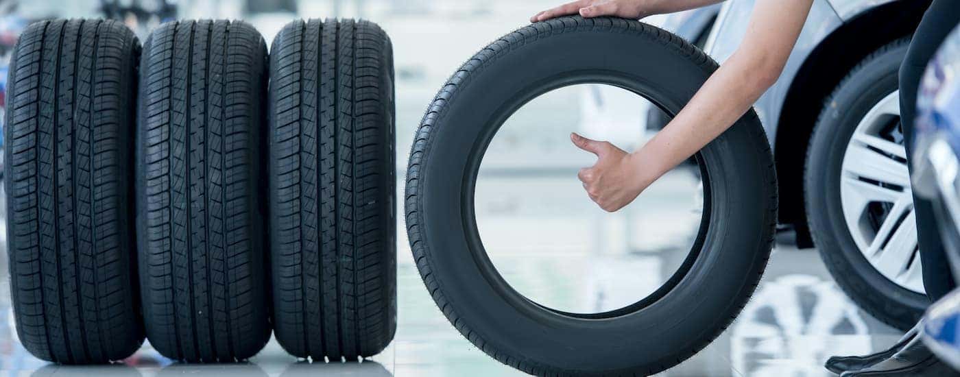 A salesperson is shown giving a thumbs up after finding the best tires in Cincinnati.