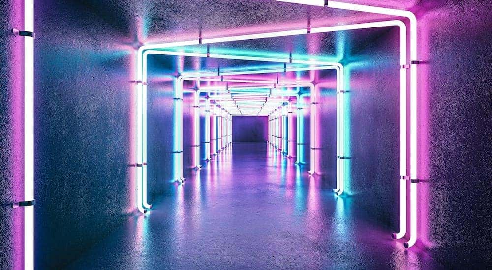 A hallway is shown with neon lights.