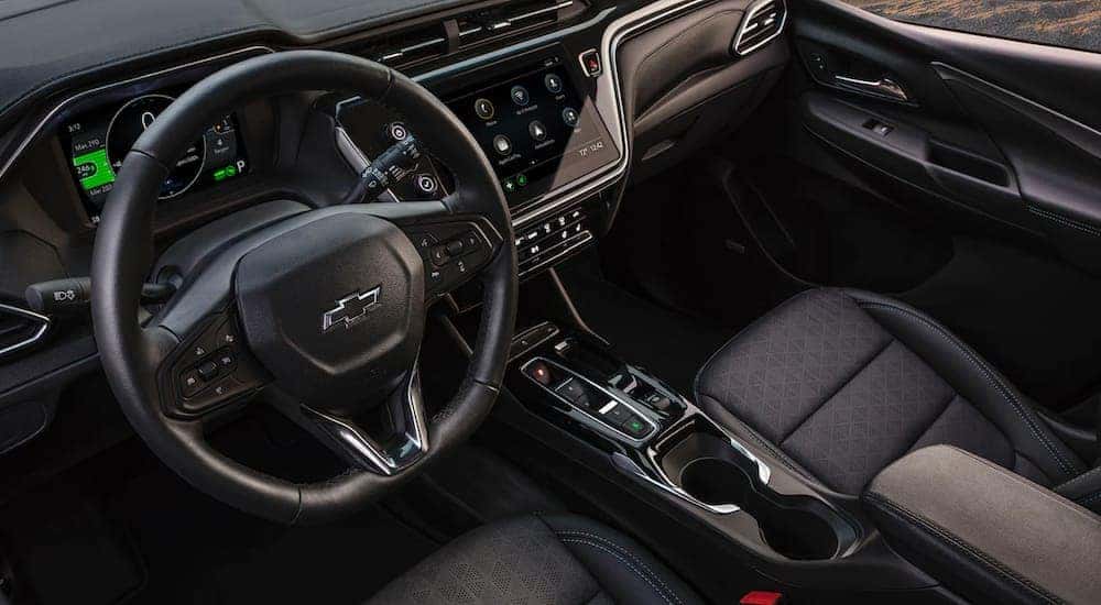 The interior of a 2022 Chevy Bolt shows the steering wheel and infotainment screen.