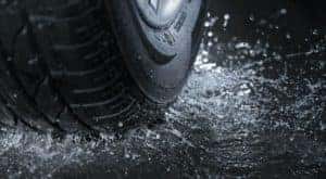 A set of good rain tires is shown in close up while shedding water.