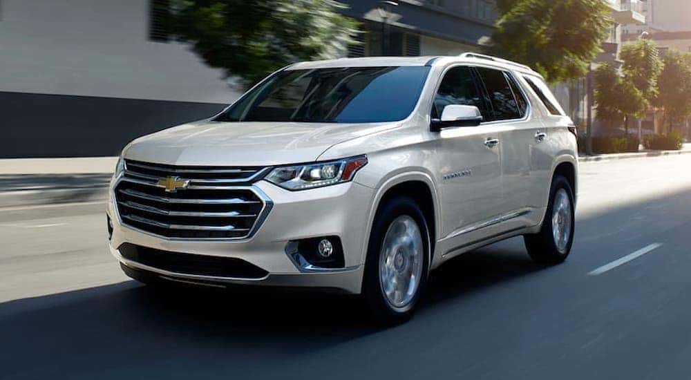 A white 2020 Chevy Traverse is shown driving down a highway after leaving a Cincinnati used car dealership.