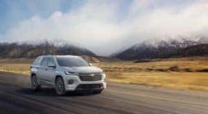 A silver 2022 Chevy Traverse is shown driving on a highway.