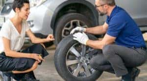 A mechanic is showing a customer a tire at one of the top tire stores in Cincinnati.