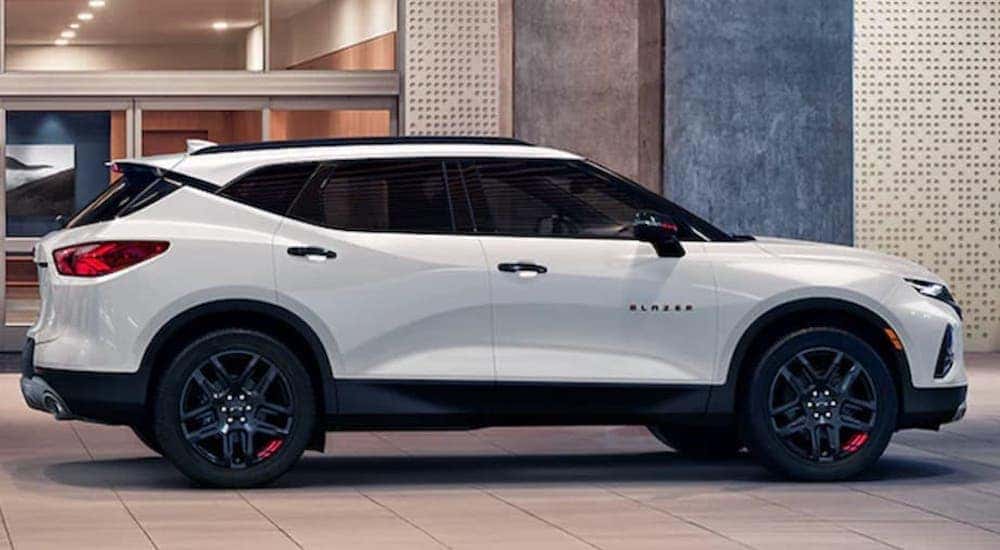 A white 2022 Chevy Blazer is shown from the side parked in a modern gallery.