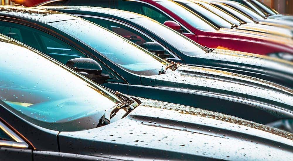 A line of Certified Pre-Owned Chevys are shown at a car lot.