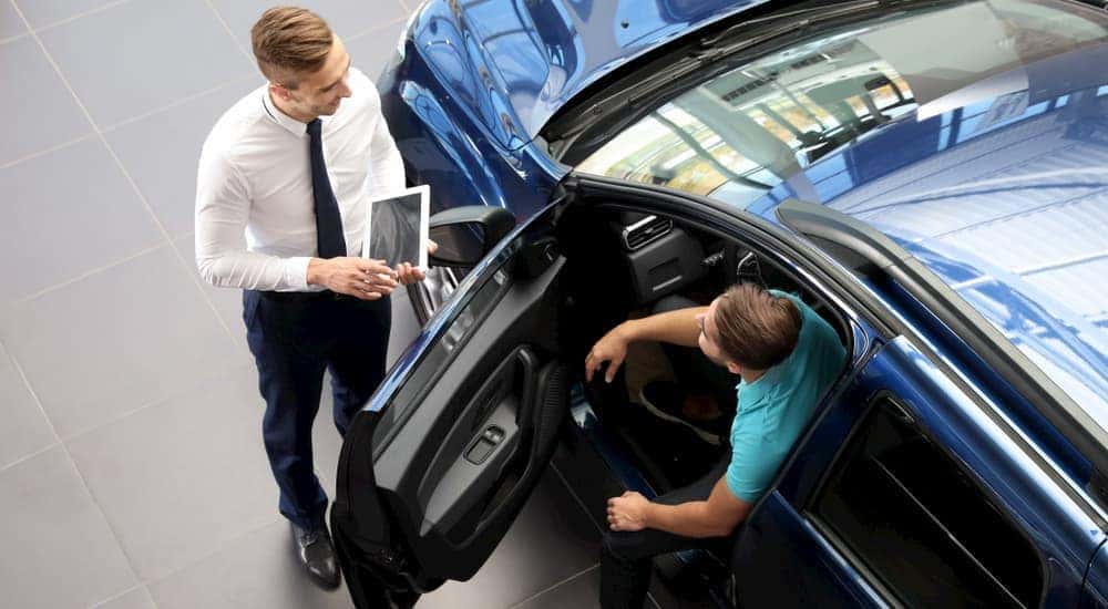 A Certified Pre-Owned Chevy salesman is shown talking to a customer.
