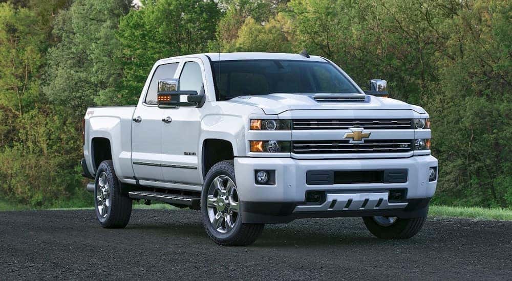 A white 2017 Chevy Silverado 2500HD is shown parked at a Cincinnati used truck dealership.