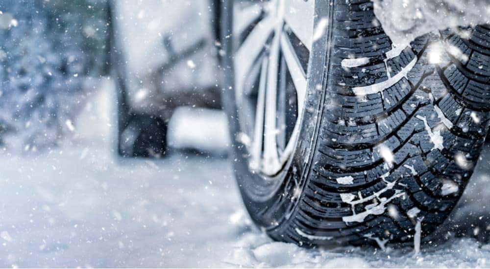 Winter tires are shown on a vehicle after visiting winter tire dealers.