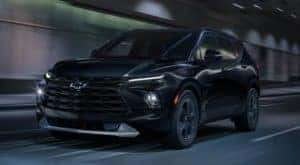A black 2023 Chevy Blazer is shown driving through a tunnel.