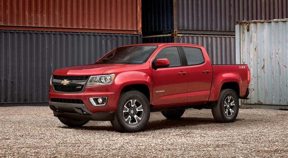 A popular Certified pre-owned Chevy, a red 2020 Chevy Colorado is shown parked from the side.