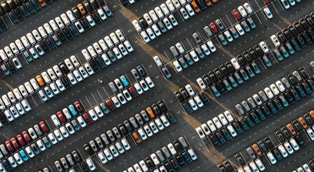 Rows of cars are shown lined up at a used car lot in Cincinnati.