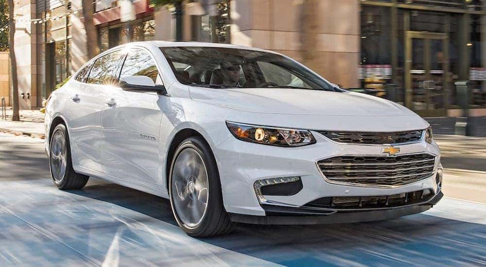 A white 2016 Chevy Malibu is shown from the front at an angle after the owner searched 'used cars in Cincinnati, OH'.