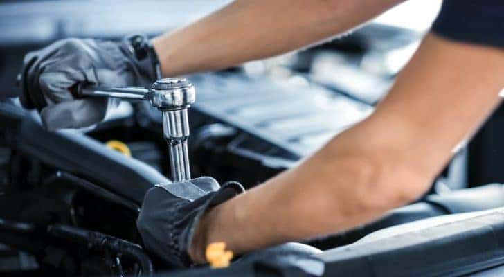 A mechanic is shown preforming an auto repair in Cincinnati.
