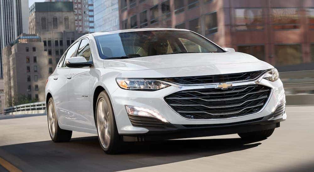 A white 2021 Chevy Malibu is shown from the front at an angle after leaving a Chevy dealer in OH.