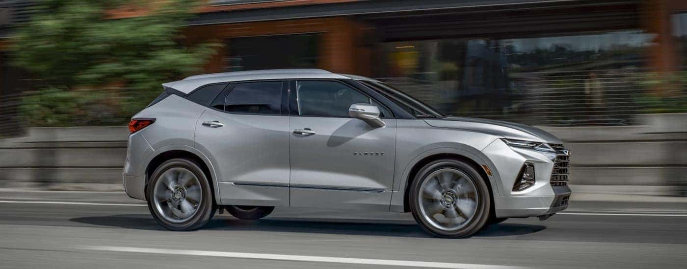 A grey 2020 Chevy Blazer is shown driving on an open road after leaving a Chevrolet dealer in OH.