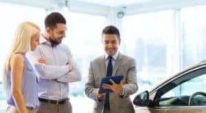 A salesperson is shown talking to customers at a Chevrolet dealer in OH.