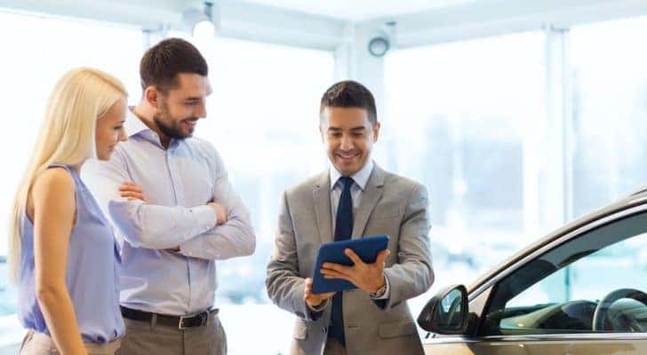 A salesperson is shown talking to customers at a Chevrolet dealer in OH.