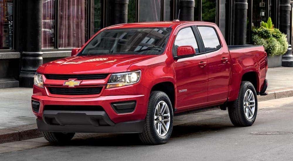 A red 2019 Chevy Colorado is shown from the side parked on a city street after looking used trucks in Cincinnati.