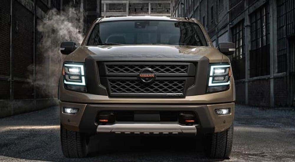 A brown 2020 Nissan Titan is shown from the front parked in an alley.