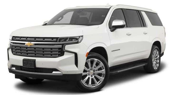 A white 2023 Chevy Suburban is shown angled left.