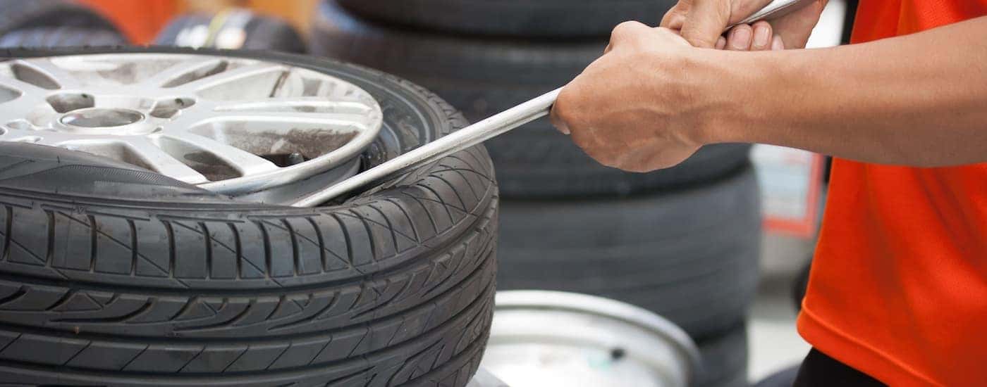 A tire is being mounted after customer searched for 'summer tires for sale near me.'