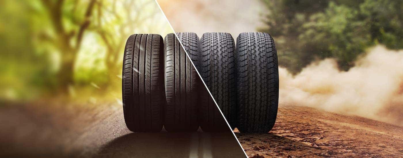 Four tires are shown in the middle of a road after searching 'all season tire dealer.'