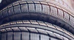 An all season tire is shown in close up.