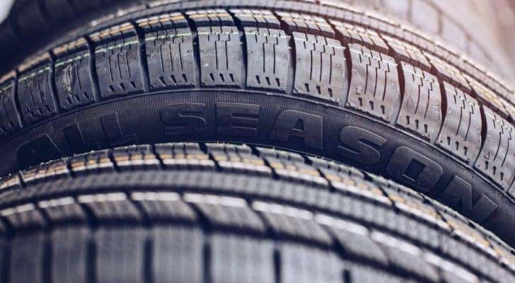An all season tire is shown in close up.
