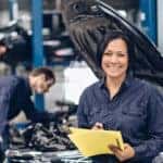 Two mechanics are shown working on a vehicle at an auto repair in Cincinnati.