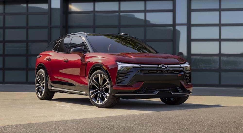 A red 2024 Chevy Blazer EV is shown from the front. 