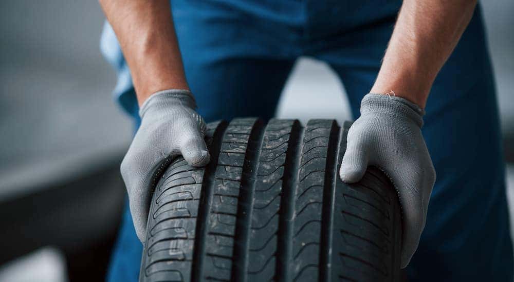 A mechanic is shown inspecting a tire.