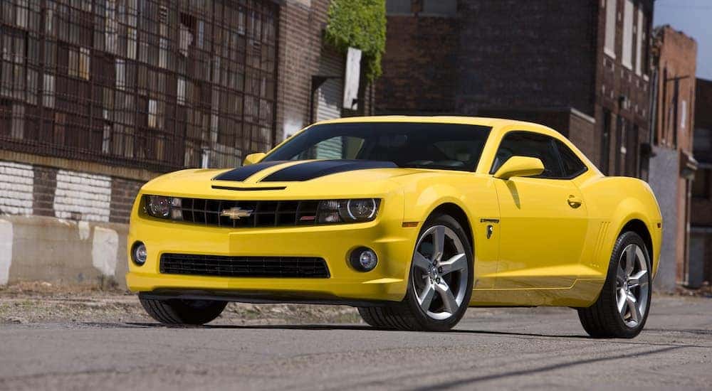 A yellow 2010 Chevy Camaro SS Transformers edition is shown from the front at an angle after the owner got it's trade in value.