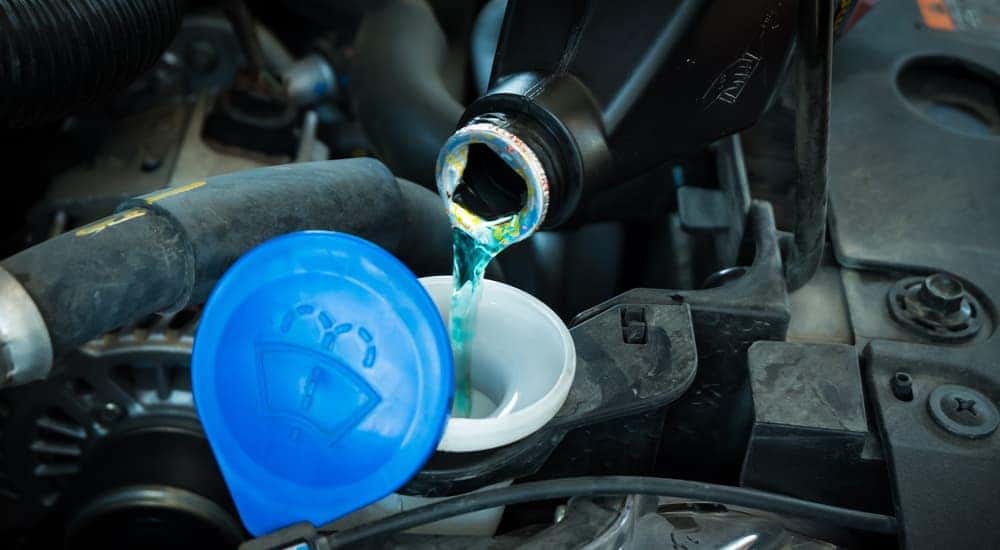 Wiper fluid is shown being refilled.