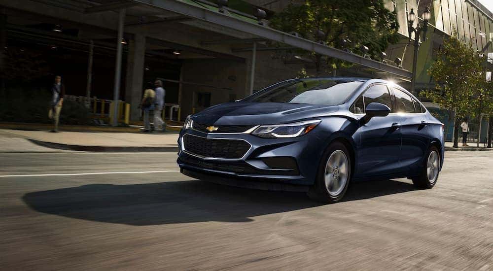 A blue 2017 Chevy Cruze is driving on a busy Cincinnati, OH street.