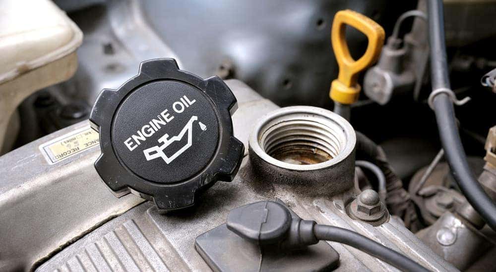 An engine oil cap is shown during an oil change.