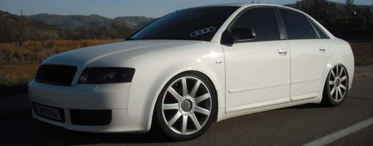 A white 2000 used Audi A4 is shown parked on pavement.