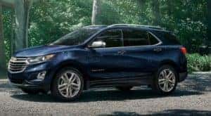 A popular used Chevy Equinox, a blue 2021 Chevy Equinox is shown from the side.