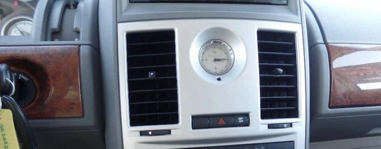 Closeup of 2009 Used Chrysler Town & Country dashboard and analog clock.