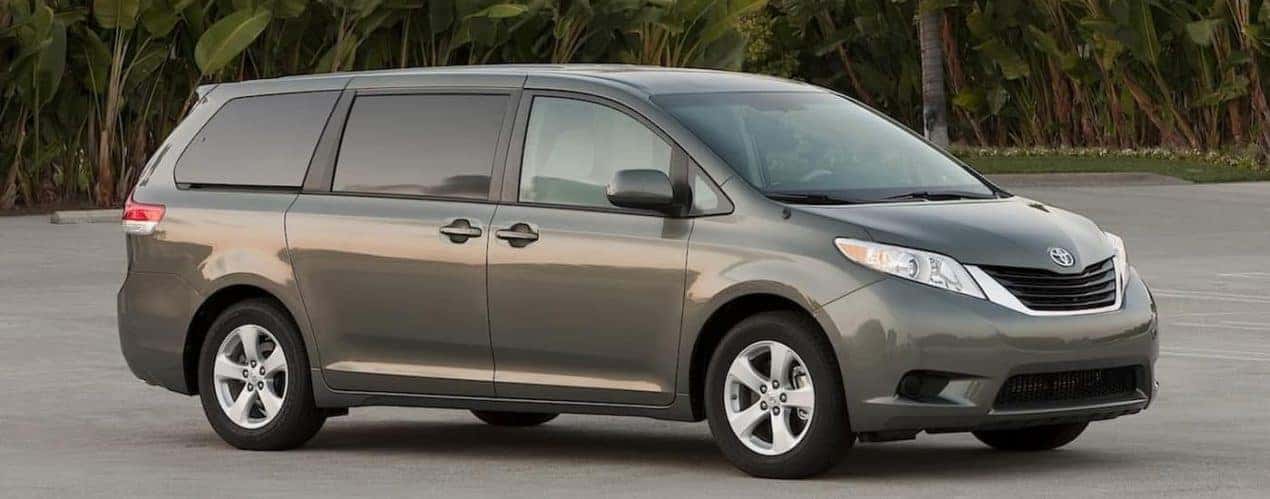 A grey 2014 Used Dodge Grand Caravan is shown from the side.
