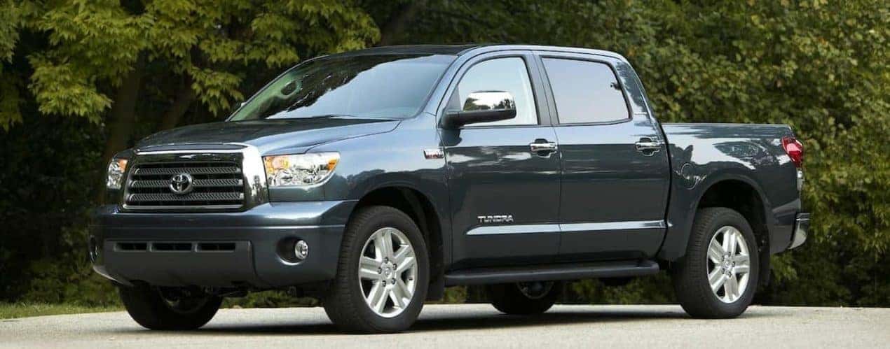 A grey 2008 used Toyota Tundra is shown parked near a forest.