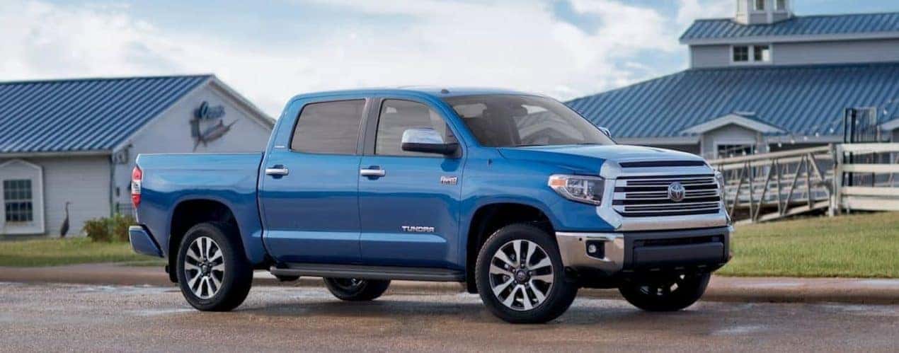 A blue 2018 Toyota Tundra is shown parked next to a restaurant.