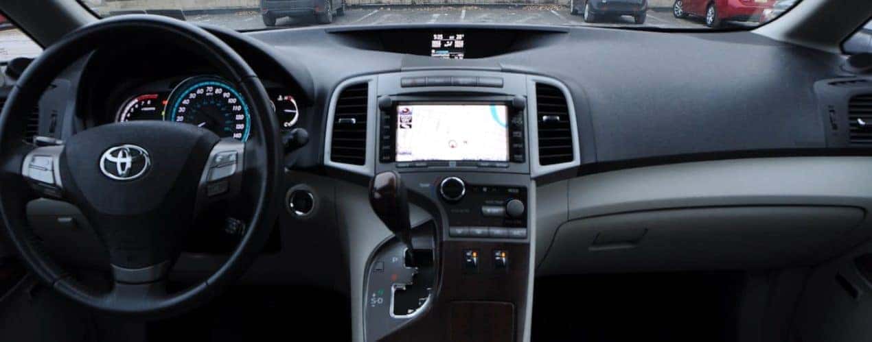 The black and gray interior of a used 2012 Toyota Venza is shown.