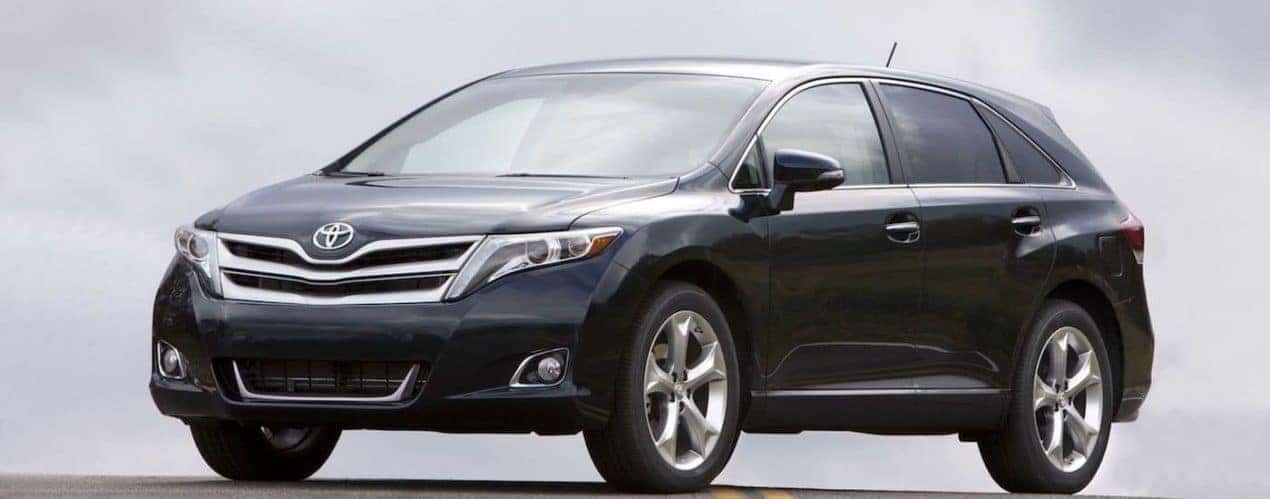 A black 2015 Toyota Venza is shown parked with a light background.