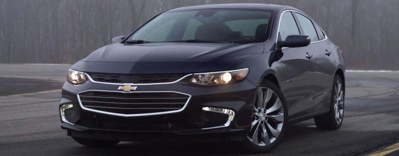 A black 2015 Chevy Malibu is shown parked in a lot.