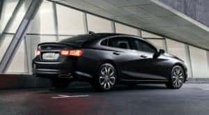 A black 2023 Chevy Malibu is shown from the side.