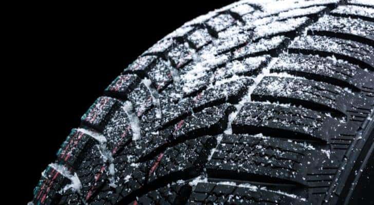 A close up of winter tires in Cincinnati are shown covered in snow.